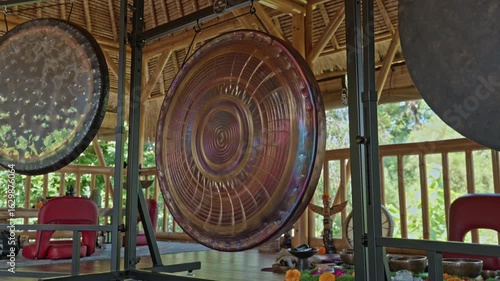 Gong standing on the floor before the start of the gong ceremony in a gazebo on the Bali island