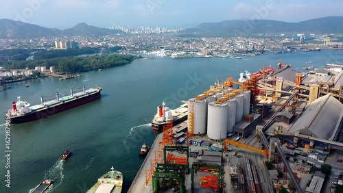 Port Of Santos In Santos Sao Paulo Brazil. Breathtaking Aerial View Of Freight Ship Sailing Near The Port. Town Sky Clouds Backgrounds Urban. Town Panorama. Santos Sao Paulo.