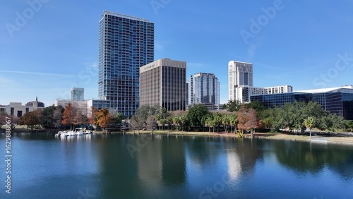 Orlando Skyline In Orlando Florida United States. Drone Captures A Garden With Sidewalks Surrounded By Lush Trees. Business Sky Downtown Cityscape. Business Backgrounds Panorama. Orlando Florida.