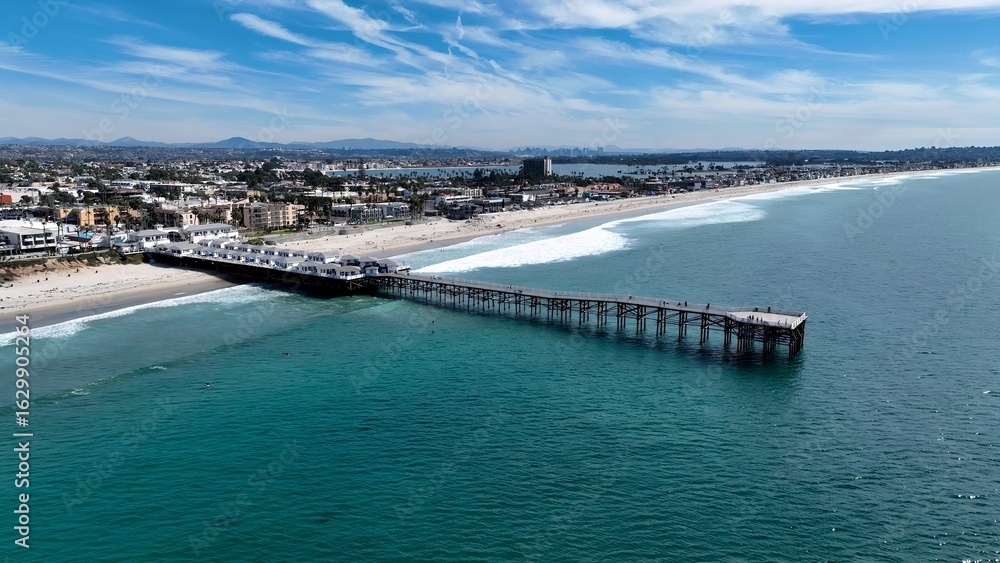 Crystal Pier In Pacific Beach San Diego United States. Cars Driving Towards Downtown City On The Famous Bridge. Coast Horizon Seaside Summertime. Coast Panoramic. Pacific Beach San Diego. Crystal Pier In Pacific Beach San Diego United States. Cars Driving Towards Downtown City On The Famous Bridge. Coast Horizon Seaside Summertime. Coast Panoramic. Pacific Beach San Diego.