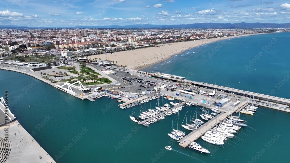 Fototapeta premium La Marina Parking In Valencia Spain. Breathtaking Aerial View Of A Lush Tropical Coastline Scenery. Town Clouds Sky Backgrounds Urban. Backgrounds Downtown Panoramic City. Valencia Spain.