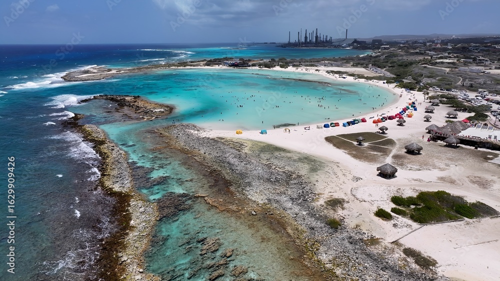 Fototapeta premium Baby Beach In San Nicolas Oranjestad Aruba. Birds Eye View Of Stunning Caribbean Beach Scenery. Coast Clouds Seaside Summertime. Outdoors Seaside Scenic Coastline. San Nicolas Oranjestad.