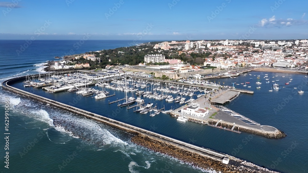 Cascais Skyline In Cascais District Of Lisbon Portugal. Turquoise Ocean Waves Gently Crashing On Tropical Beach. Coast Horizon Seaside Summertime. Coast Panoramic. Cascais District of Lisbon. Cascais Skyline In Cascais District Of Lisbon Portugal. Turquoise Ocean Waves Gently Crashing On Tropical Beach. Coast Horizon Seaside Summertime. Coast Panoramic. Cascais District of Lisbon.