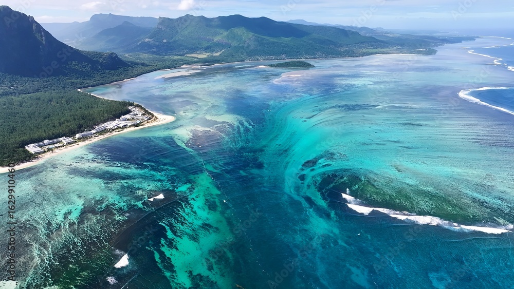 Fototapeta premium Underwater Waterfall In Le Morne Beach Mauritius Island Mauritius. Breathtaking Aerial View Of A Lush Tropical Coastline Scenery. Coast Horizon Seaside Summertime. Coast Panoramic.