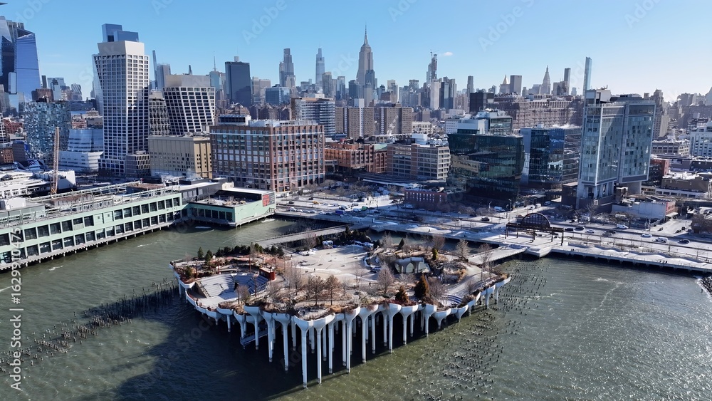 Obraz premium Pier 57 In Manhattan New York United States. Aerial View Of A Bustling City With High-Rise Buildings And Traffic. Town Sky Backgrounds Urban. Town Outdoor Panning Wide. Manhattan New York.