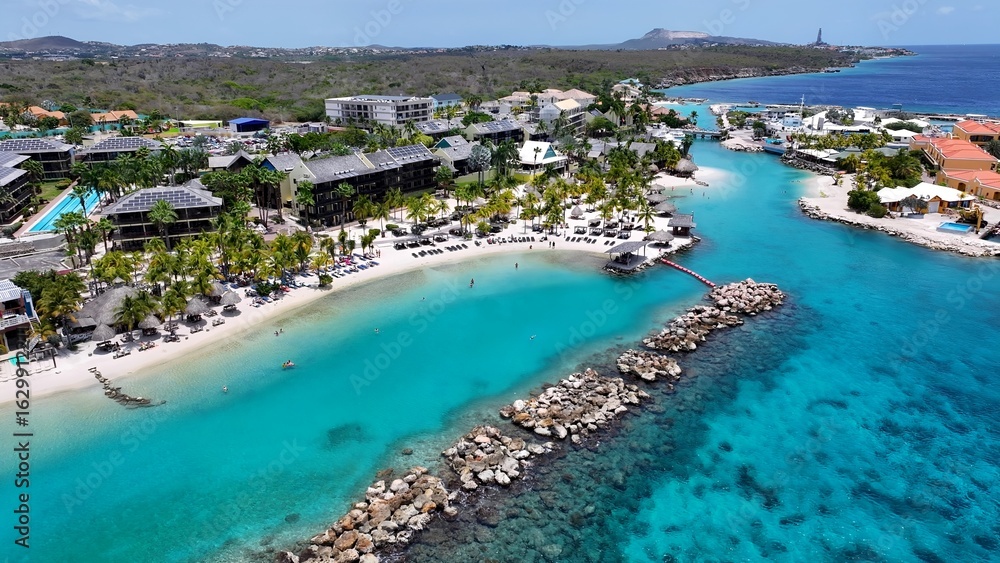 Obraz premium Beach Resort In Willemstad Netherlands Curacao. Capturing The Beauty Of A Tropical Beach From Above. Shore Clouds Sky Beach Sea. Shore Travel. Willemstad Netherlands.