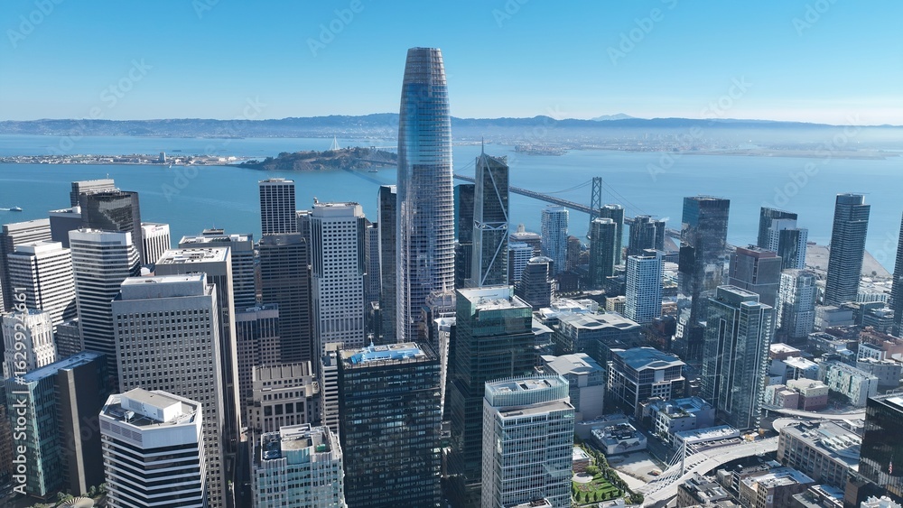 Fototapeta premium Downtown City In San Francisco California United States. Aerial View Of A Bustling City With High-Rise Buildings And Traffic. Business Clouds Sky Downtown Cityscape. Backgrounds Panoramic.