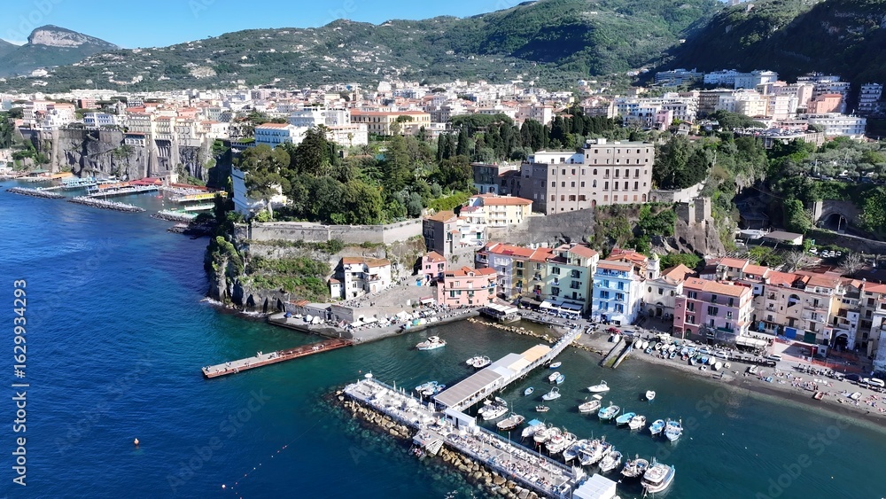 Fototapeta premium Sorrento Coast In Sorrento Naples Italy. Boat Sailing With Tourists Enjoying The Trip In A Sunny Day. Island Life Landscape Peaceful Beautiful. Island Life Watercolor Coast. Sorrento Naples.
