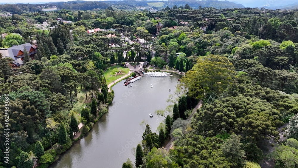 Fototapeta premium Lago Negro In Gramado Rio Grande Do Sul Brazil. Aerial View Of A River Surrounded By Lush Green Tropical Rainforest. Business Clouds Sky Downtown Cityscape. Backgrounds Panoramic.