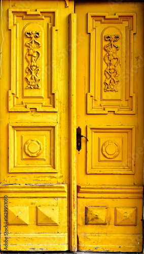 Old wooden yellow door from 19 century.