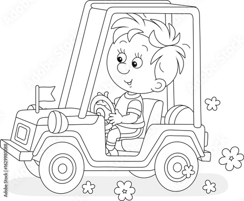 Happy little boy driving a ...