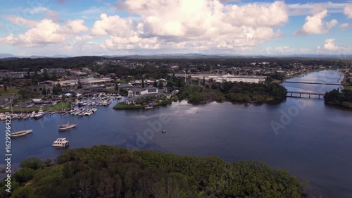 Aerial drone shot of La Gi coastal town with scenic marina, river, and surrounding infrastructure in Binh Thuan Province, Vietnam. Capturing natural beauty and development