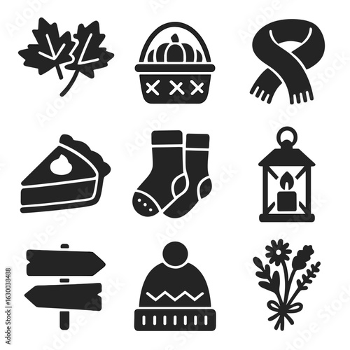 Fall-Themed Icon Set. Solid, filled icons set of fall-themed decorations: maple leaves, harvest basket, warm