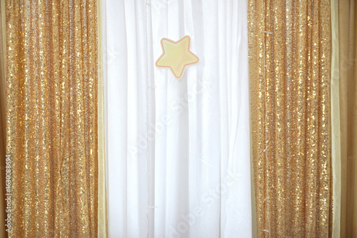 Sparkling gold sequins and soft white drapes create a festive, elegant backdrop for any celebration.