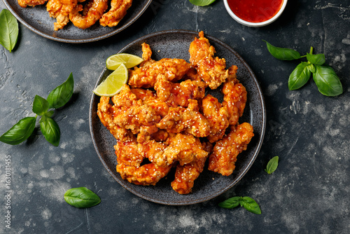 Korean fried chicken with spicy sauce and sesame seeds