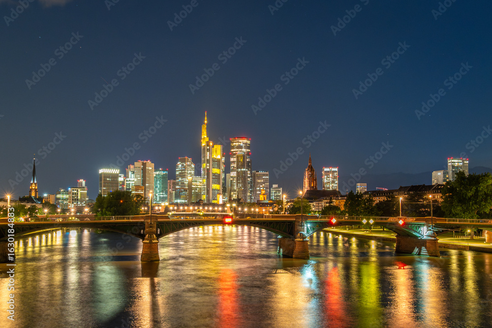 Obraz premium Illuminated Frankfurt City Downtown, Ignatz Bubis Bridge and Main River at Night. Hesse, Germany