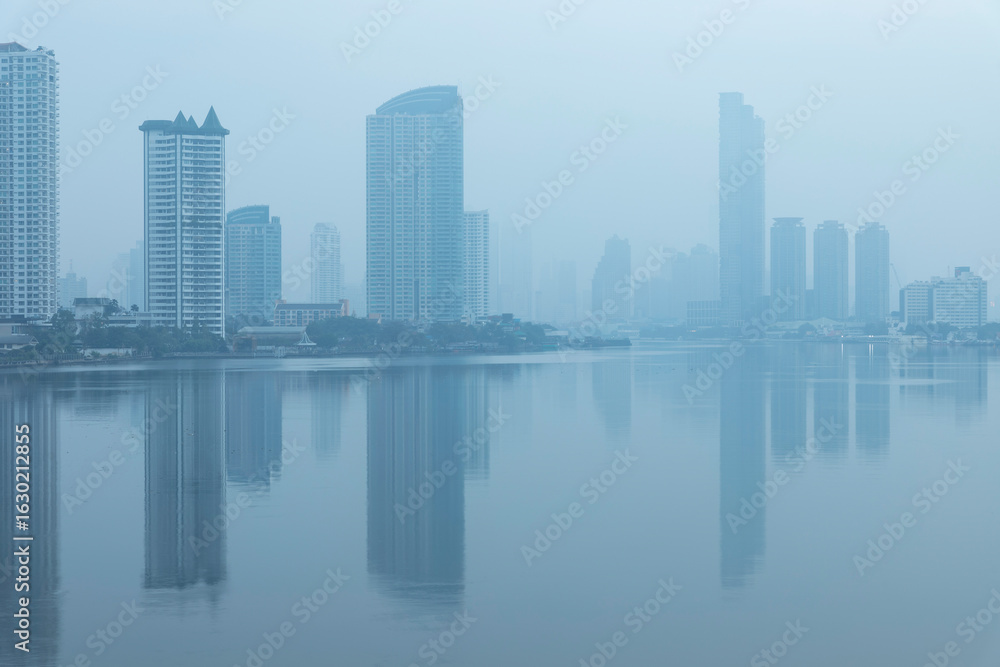 Obraz premium Bangkok office buildings and condominium with Chao Phraya river and chips. Office building under smog in Sathorn Bangkok. Smog PM 2.5 is a kind of air pollution. Bangkok City in the air pollution.