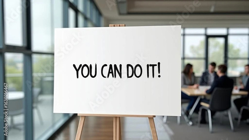 White motivational board with caption 'you can do it!' in the modern office. 