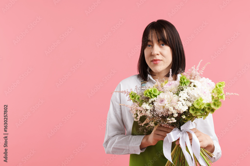 Florist with beautiful bouquet of flowers on pink background, space for text Florist with beautiful bouquet of flowers on pink background, space for text