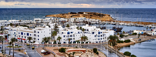 Panoramic view of monastir marina with white buildings and docked boats in tunisia