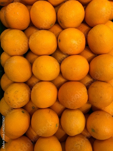 Fresh organic oranges, lemons, and other healthy citrus fruits are ripe and juicy in a colorful market display
