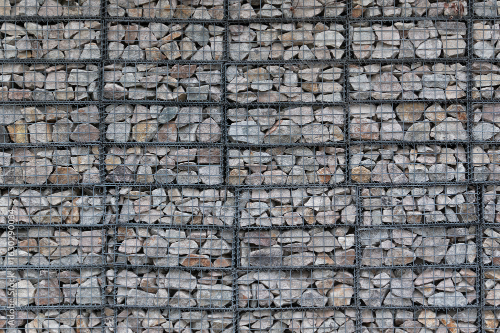 Fototapeta premium wall made by wire mesh cages with stones at horizontal composition