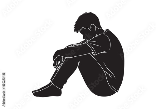 A silhouette of a sad, lonely man sitting hunched over, his head bowed in despair and sorrow.