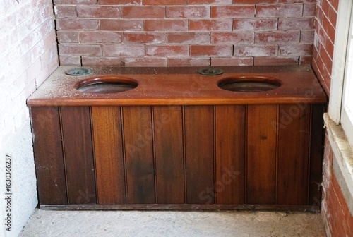 Картината върху платно A vintage wooden toilet with its simple design reflecting a bygone era