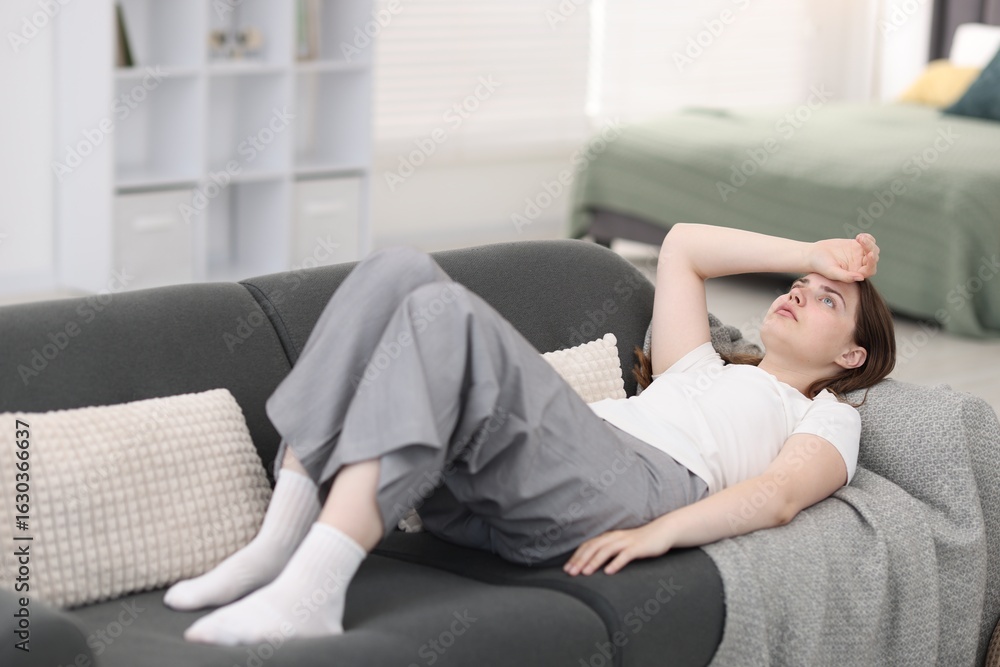 Young woman suffering from headache at home Young woman suffering from headache at home