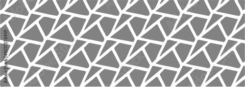 Abstract broken tile design in grayscale with irregular polygon shapes.
