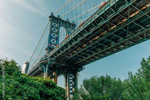 Looking up at the Manhattan Bridge from Washington Street in DUMBO, Brooklyn, New York City, on a sunny day.