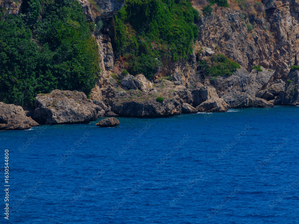 Naklejka premium Rocky coastline with blue sea view