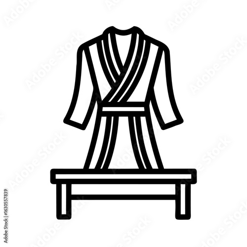 Elegant bathrobe draped over a stylish bench for home relaxation and spa enjoyment