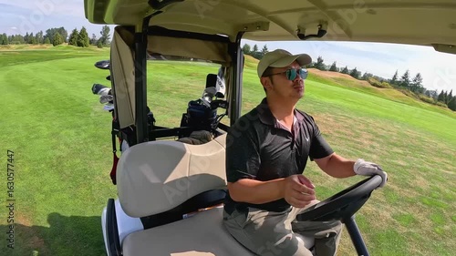 Asian man drives a golf power cart 