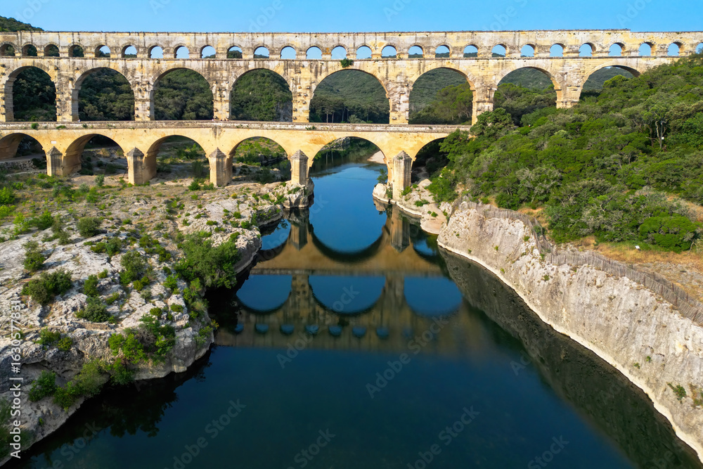 Fototapeta premium Pont du Gard, ancient Roman aqueduct bridge built in the first century AD crossing river Gardon in southern France, a world heritage site