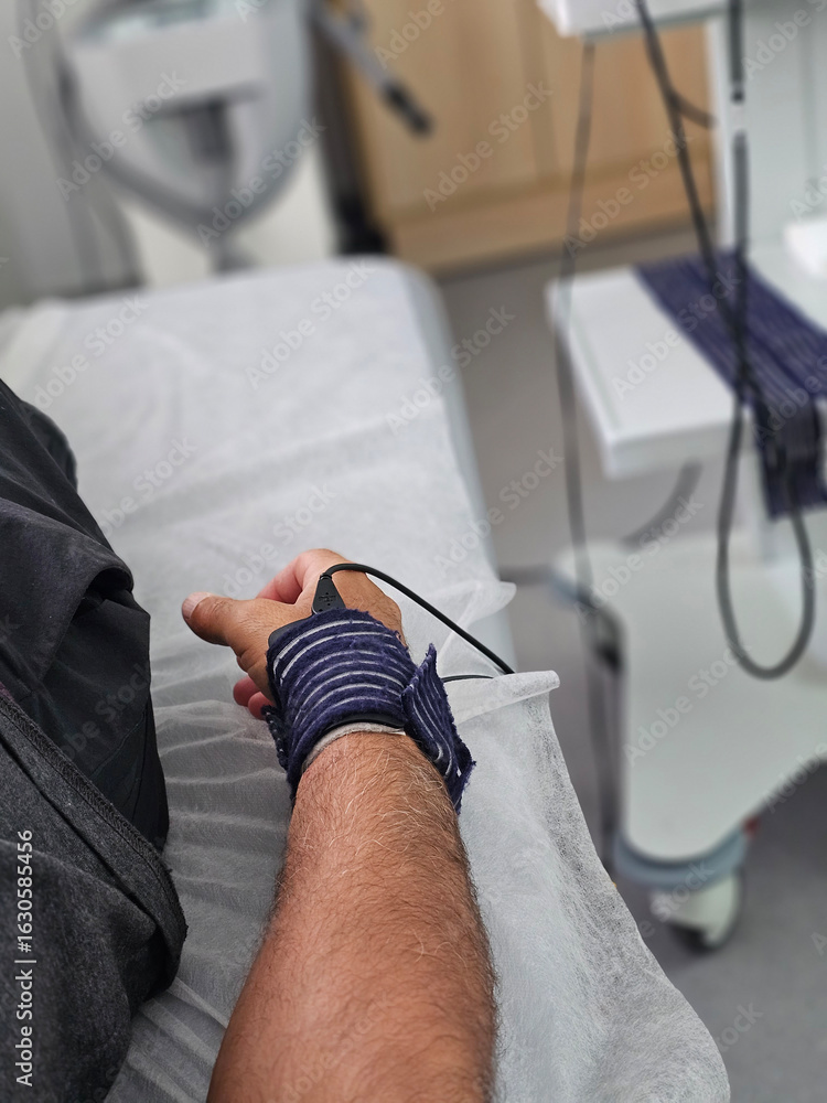 Fototapeta premium Patient receiving treatment in a medical facility with monitoring equipment present concept