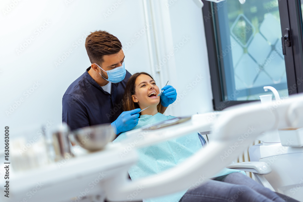 Fototapeta premium Male Dentist Treating Female Patient’s Teeth