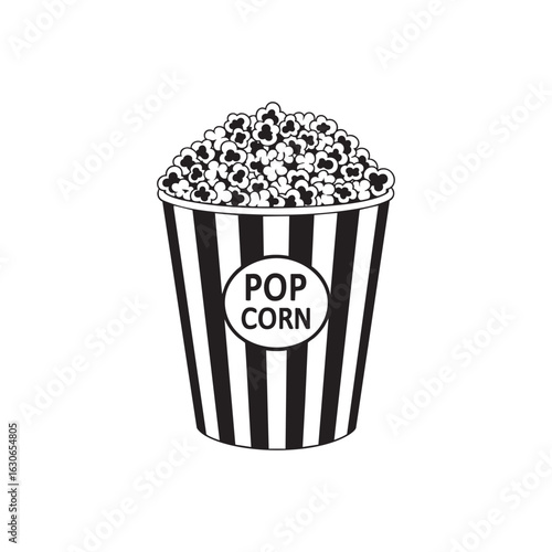 Classic black and white striped popcorn bucket filled with fluffy popcorn isolated on a white background