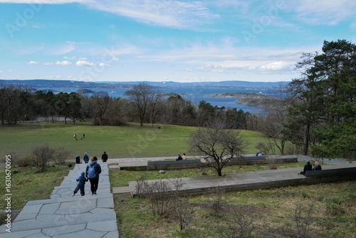 Scenic View of Oslofjord with Visitors Enjoying a Peaceful Park Setting Overlooking the Ocean and Distant Islands in Oslo, Norway
