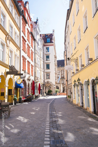 Empty cobblestone street with colorful old buildings in Munich.