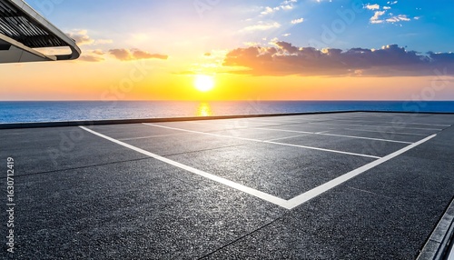Fototapeta Naklejka Na Ścianę i Meble -  Empty parking lot at sunset over ocean