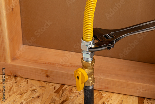 Installing natural gas or propane flexible line. Plumbing, home maintenance, repair and remodeling concept.