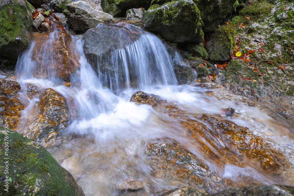 Fototapeta premium Waterfall on a stream in forest at autumn.The rocky gorge Dolne diery in The Mala Fatra National Park, Slovakia, Europe.