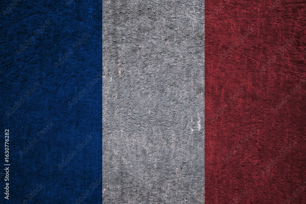Fototapeta premium French flag on a textured uneven wall, patriotic photo