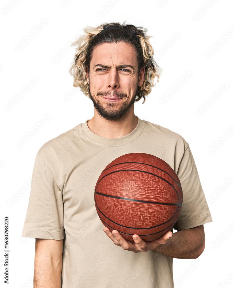 Casual young basketball player in studio confused, feels doubtful and unsure. Casual young basketball player in studio confused, feels doubtful and unsure.