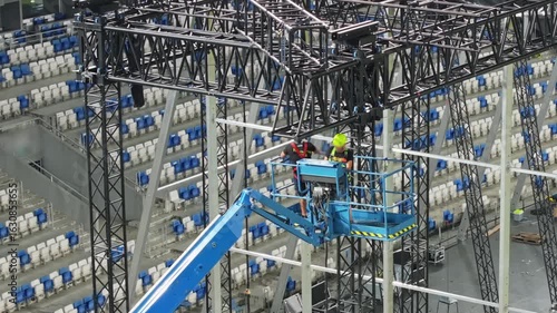 Music concert stage set up buildup construction. stadium football pitch being prepared to host a music concert. sports stadium as technicians set up the stage for the live music event.