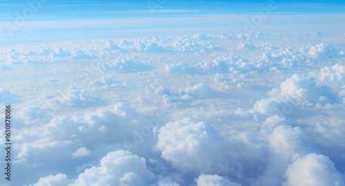 Aerial View of Fluffy White Clouds Against a Pale Blue Sky