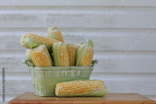 Fotografie Sweet corn in a basket, free space, place for, text, summer, harvest, healthy fo
