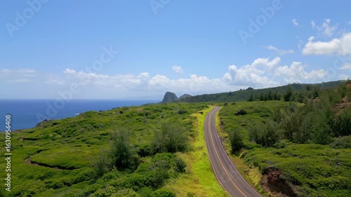 Aerial Drone View of the Empty Kahekili Highway Leading Towards the Iconic Puʻu Koaʻe Peak on the Scenic Coastline of West Maui, Hawaii