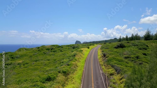 Aerial Drone View of the Empty Kahekili Highway Leading Towards the Iconic Puʻu Koaʻe Peak on the Scenic Coastline of West Maui, Hawaii